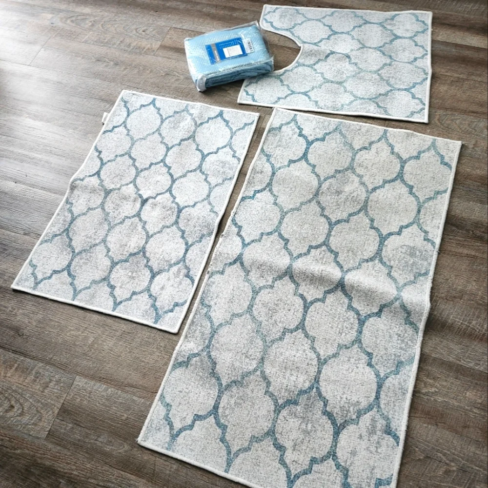 Bathroom rugs plus curtain.